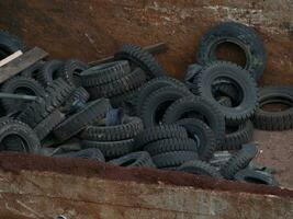 Old tires in rusted container photo