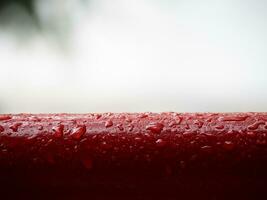 Red metal railing handle in the rain photo