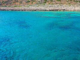 Beautiful turquoise water and rocky coastline photo