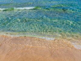 Blue sea water and beautiful orange beach sand - Crete, Greece photo