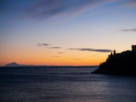 Sunset and island of Thassos on the horizon photo