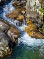 Beautiful blue water in the cool mountain stream creek photo