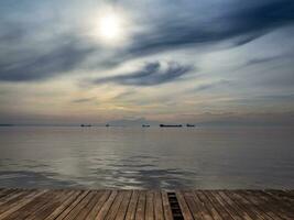 Big trade and transport ships on the horizon - strange clouds in the sky photo