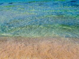 Amazing clear blue water and clean sandy beach photo