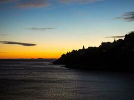 Sunset over the old part of town near the sea - Kavala, Greece photo