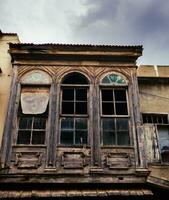 Old wooden abandoned building with broken windows photo