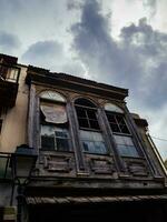 Abandoned old house in the old part of town - storm clouds looming above photo