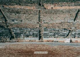 Ancient stone Greek amphitheatre ruins photo