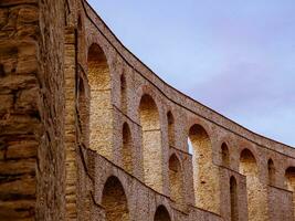 Curved ancient Roman aqueduct in center of Kavala city - Greece photo