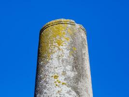 Remains of a ancient Greek column - clear blue sky background photo