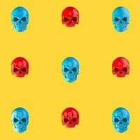 Bright red and blue skulls pattern on sunny yellow background photo