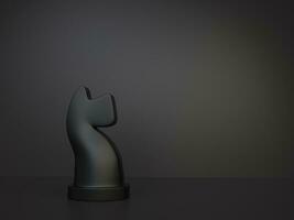 Black knight chess figurine on dark background photo