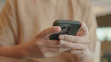 Close-up of a man sitting and typing a message on his smartphone in the network chat app. video