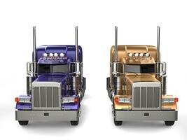 Purple and gold big semi - trailer trucks - side by side - front view photo