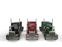 Black, red, and green classic eighteen wheeler trucks without trailers - top down view photo