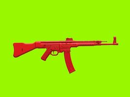 Red assault machine gun on green background photo