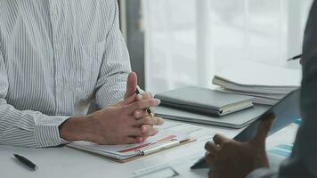 Group of confident business people point to graphs and charts to analyze market data, balance sheet, account, net profit to plan new sales strategies to increase production capacity. video