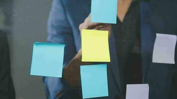 Group of confident business people point to graphs and charts to analyze market data, balance sheet, account, net profit to plan new sales strategies to increase production capacity. video