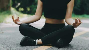 Young fitness woman runner stretching legs before run on city video