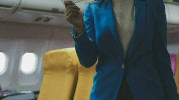 Traveling and technology. Flying at first class. Pretty young businees woman using smartphone while sitting in airplane. video