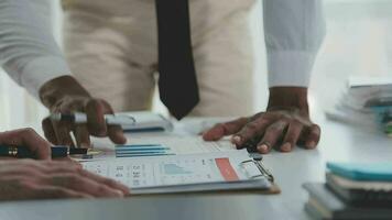 Group of confident business people point to graphs and charts to analyze market data, balance sheet, account, net profit to plan new sales strategies to increase production capacity. video