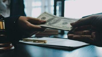 Business and lawyers discussing contract papers with brass scale on desk in office. Law, legal services, advice, justice and law concept picture with film grain effect video