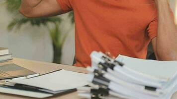 Young business man working at home with laptop and papers on desk video