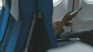 portrait of A successful asian business woman or female entrepreneur in formal suit in a plane sits in a business class seat and drink coffee during flight, relax concept video