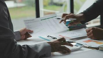 Group of confident business people point to graphs and charts to analyze market data, balance sheet, account, net profit to plan new sales strategies to increase production capacity. video