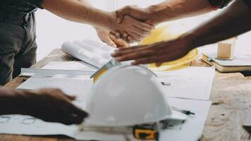 Image of team engineer checks construction blueprints on new project with engineering tools at desk in office. video