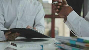 Group of confident business people point to graphs and charts to analyze market data, balance sheet, account, net profit to plan new sales strategies to increase production capacity. video