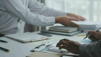 Group of confident business people point to graphs and charts to analyze market data, balance sheet, account, net profit to plan new sales strategies to increase production capacity. video