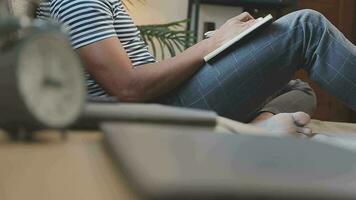 Young business man working at home with laptop and papers on desk video