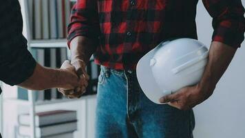 Image of team engineer checks construction blueprints on new project with engineering tools at desk in office. video