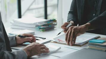 Group of confident business people point to graphs and charts to analyze market data, balance sheet, account, net profit to plan new sales strategies to increase production capacity. video