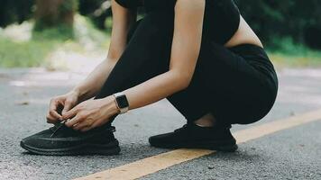 Young fitness woman runner stretching legs before run on city video