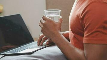 Freelancer drinking water sitting at table video