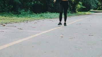 A young woman runner runs at sunset in a park in the park. video