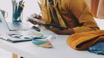 A few finishing touches and itll be ready. Shot of a young fashion designer working on a garment hanging over a mannequin. video