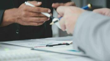 Group of confident business people point to graphs and charts to analyze market data, balance sheet, account, net profit to plan new sales strategies to increase production capacity. video