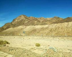 Road going through Sinai mountains, hills and desert photo