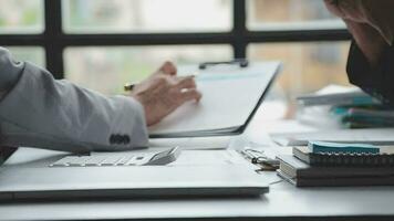 Group of confident business people point to graphs and charts to analyze market data, balance sheet, account, net profit to plan new sales strategies to increase production capacity. video