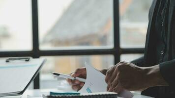 Group of confident business people point to graphs and charts to analyze market data, balance sheet, account, net profit to plan new sales strategies to increase production capacity. video