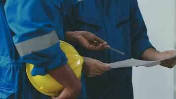 Three Heavy Industry Engineers Stand in Pipe Manufacturing Factory, Use Digital Tablet Computer, Have Discussion. Large Pipe Assembled. Design and Construction of Oil, Gas and Fuels Transport Pipeline video