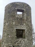 Old celtic tower, Blarney castle in Ireland, ancient architecture background photo