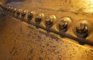 Metal background, old copper wall with rivets photo