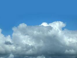 White clouds over blue sky background. Fluffy cumulus cloudscape shape photo