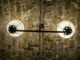 Old ancient lamps on the wall in a dark room background, gloomy light photo