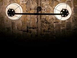 Old ancient lamps on the wall in a dark room background, gloomy light photo