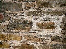 Old stone wall pattern close view background, ancient bricks surface photo